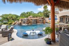 Sun shelf curving around tropical plants and outdoor living space Sun shelf curving around tropical plants and outdoor living space