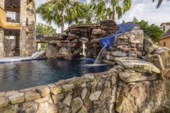 Sunlit luxury waterslide and pool area with seamless integration into backyard hardscape. Sunlit luxury waterslide and pool area with seamless integration into backyard hardscape.