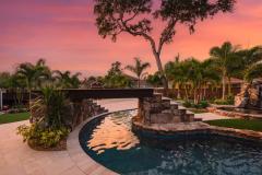 Signature Series Insane Pool with Ipe wood bridge at night Signature Series Insane Pool with Ipe wood bridge at night