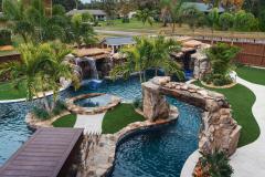 Signature Series Insane Pool with massive grotto and Ipe bridge to the spa island Signature Series Insane Pool with massive grotto and Ipe bridge to the spa island