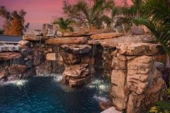 Signature Series Insane Pool with grotto at night Signature Series Insane Pool with grotto at night