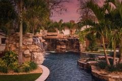 Signature Series Insane Pool with grotto at night Signature Series Insane Pool with grotto at night
