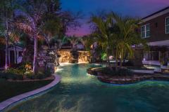 Signature Series Insane Pool with grotto at night Signature Series Insane Pool with grotto at night