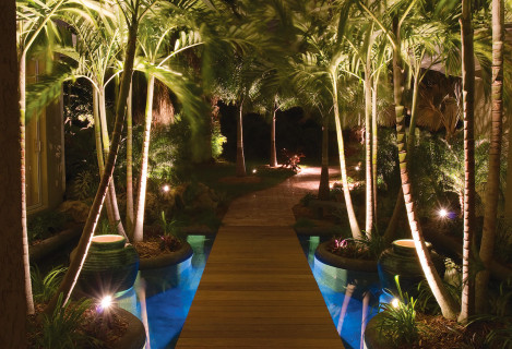 Custom Swimming Pool with Natural Stone Waterfalls and Pool Grotto entryway looking out