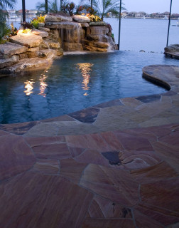 Flagstone deck, waterfall grotto and infinity edge