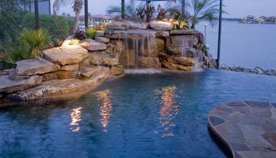Grotto and infinity edge pool with flagstone deck