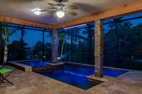 View from the house to the modern pool and rain curtain