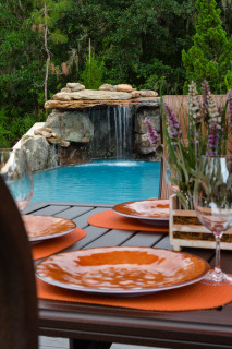 Looking over an outdoor dining area to a new lagoon pool waterfall