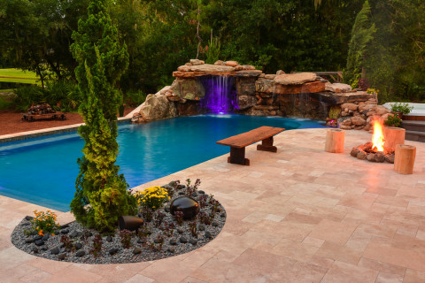 Full view of the natural rock lagoon pool, complete with outdoor sound system, fire pit and seating areas