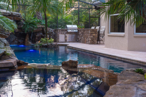Spa overlooking pool to the outdoor kitchen