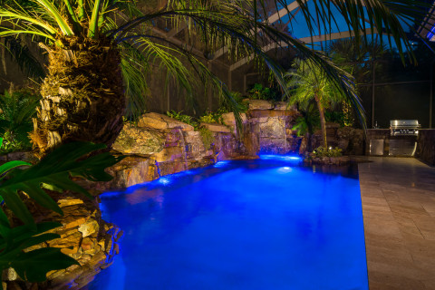 Spa, Waterwall, Grotto and Outdoor Kitchen lit up at night