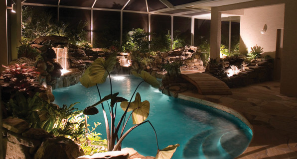 lucas lagoons pool remodel with wooden bridge night view entrance
