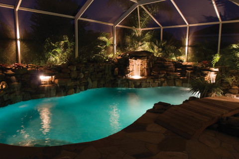 lucas lagoons pool remodel with wooden bridge night view