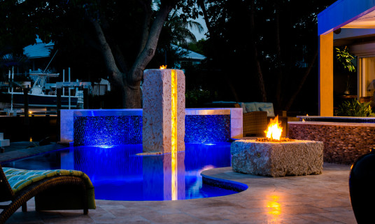The warm glow of the Fire contrasts the deep blue of the Modern Pool