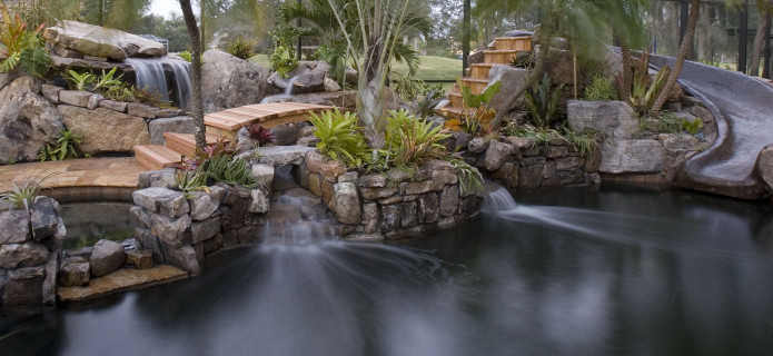 wide-view-with-slide-stream-grotto-waterfall-wooden-bridge_4643116557_o