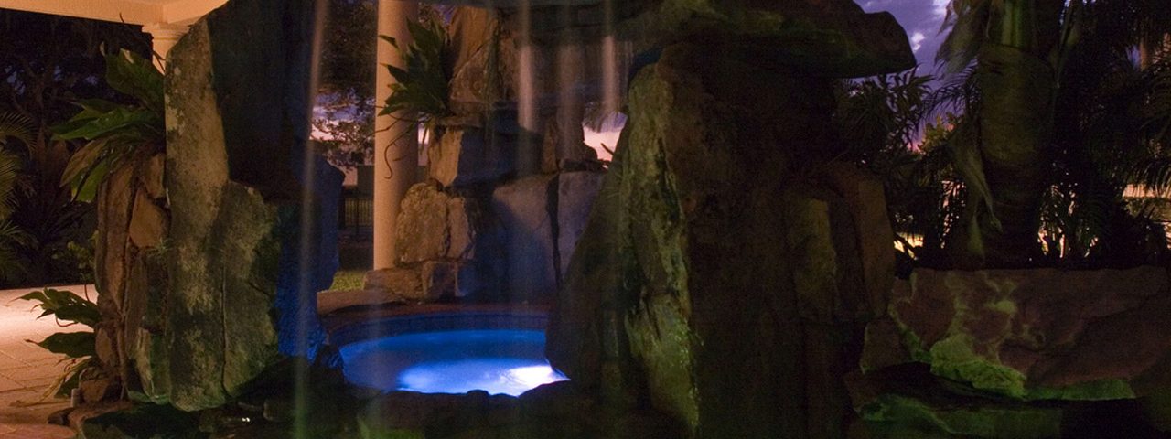 Siesta Key Swimming Pool with Tall Grotto Waterfall and Underwater Lighting